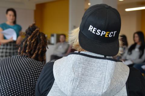 A student with back turned to the camera wearing a GLSEN respect hat.